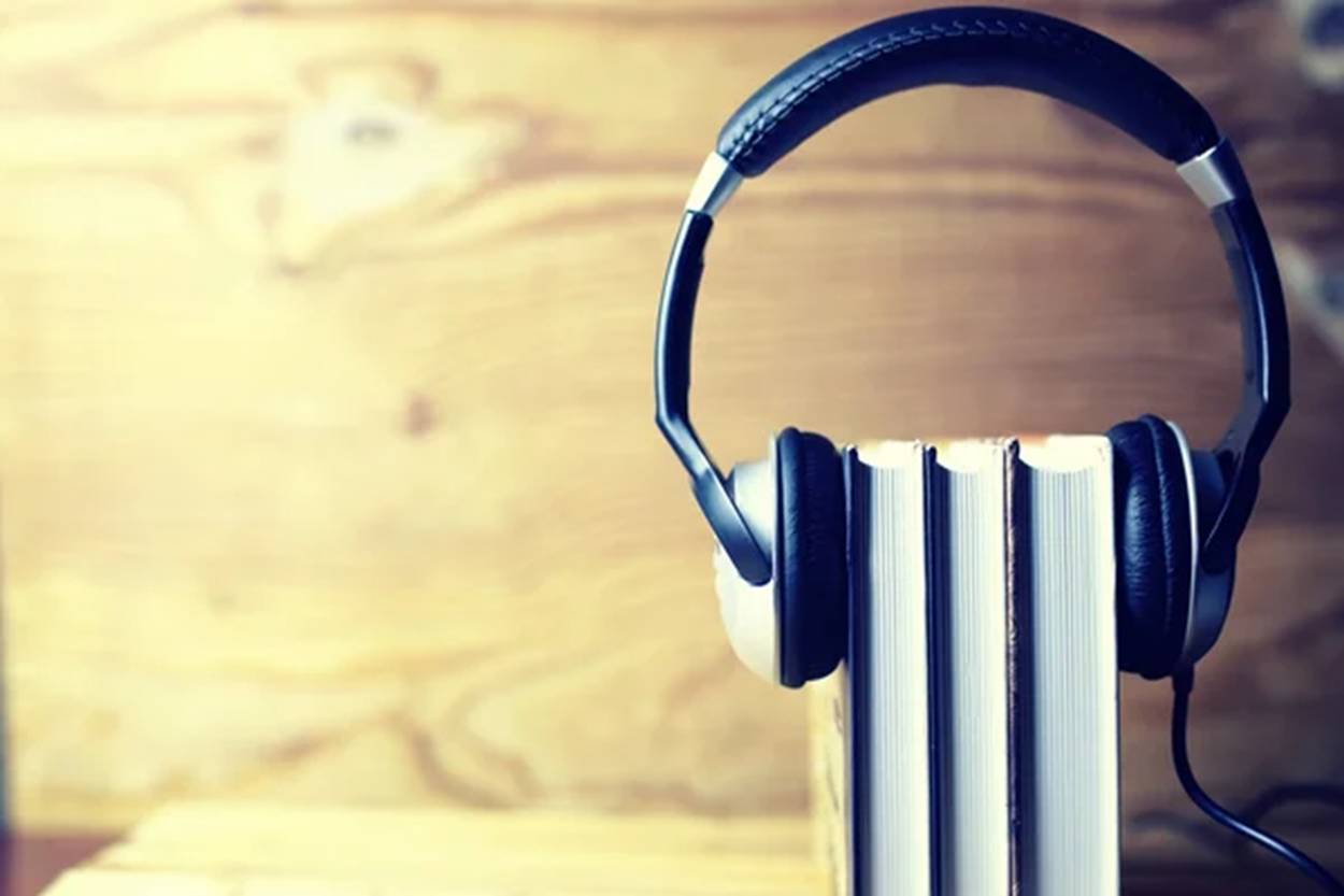 A pair of headphones on top of books.