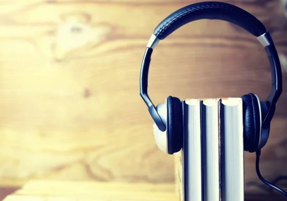 A pair of headphones on top of books.